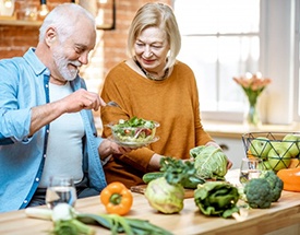 a mature couple preparing a healthy meal