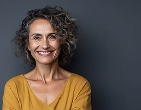 a woman smiling with healthy dentures