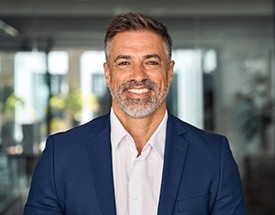 a professional man smiling with dentures