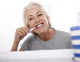 Woman brushing teeth in Cumming