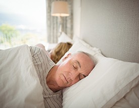 Man asleep with dental implants in Cumming
