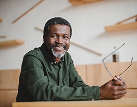 Man smiles with dental implants in Cumming