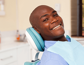 Man with flawless white smile in dental chair