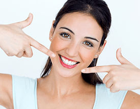 Woman pointing to bright white smile