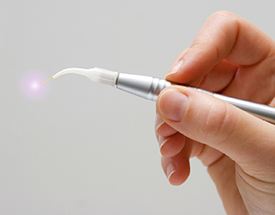 Hand holding a dental laser tool