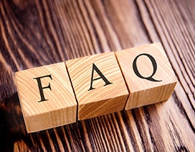 Wooden FAQ letter blocks on wooden desk