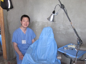Dr. Lee beside exam chair