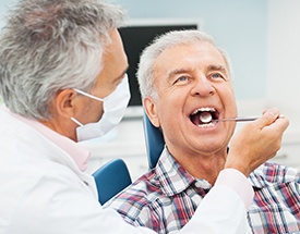 Senior man in dental chair for exam