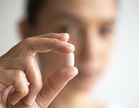 Hand holding a sedative pill