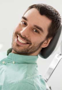 Man smiling while getting a dental checkup