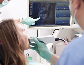 Dentist and patient looking at intraoral photos