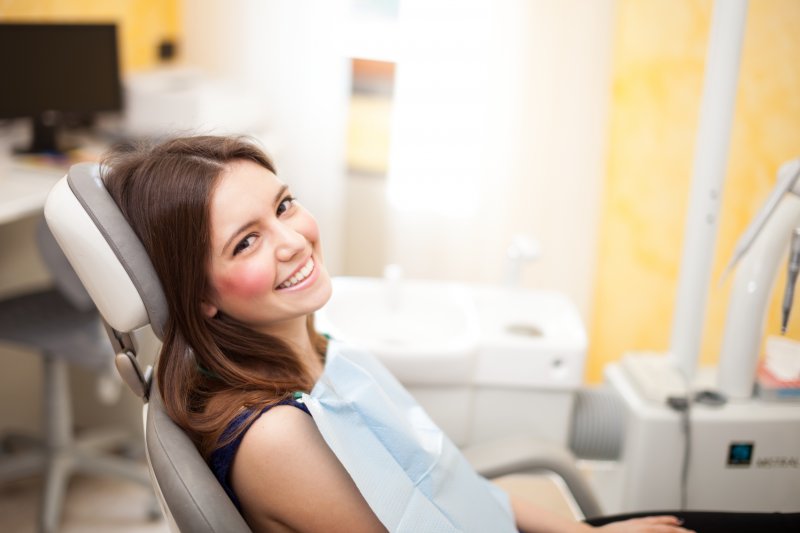 woman smiling sitting dentist chair