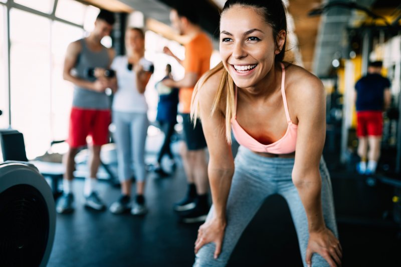 A smiling woman doing an exercise